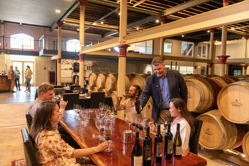 People seated at a table doing wine tasting